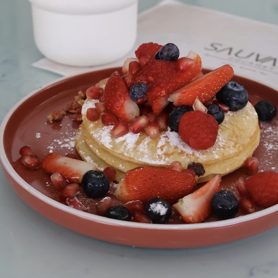 Three homemade pancakes, raspberry, blueberry, strawberry, homemade granola